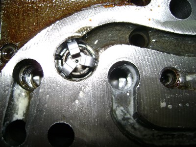 Degraded hydraulic oil deposit on parts