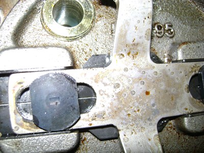Degraded hydraulic oil deposit on parts