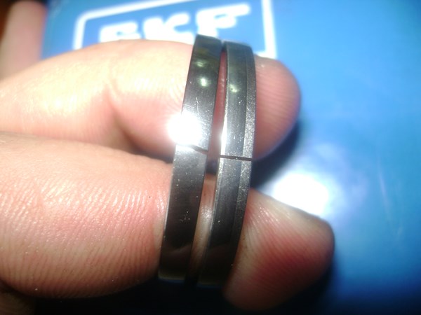 The crooked gap of an aftermarket piston ring side by side with an original Rexroth ring