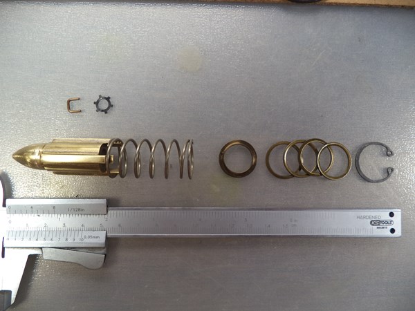 Flow metering tapered piston assembly