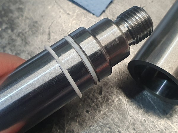 Stretching a plastic back-up ring over the groove and then cutting the protruding part off fills the groove for a safer assembly