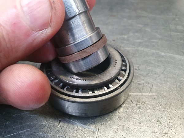 A small bearing makes an excellent compression sleeve for a bronze-filled PTFE piston seal