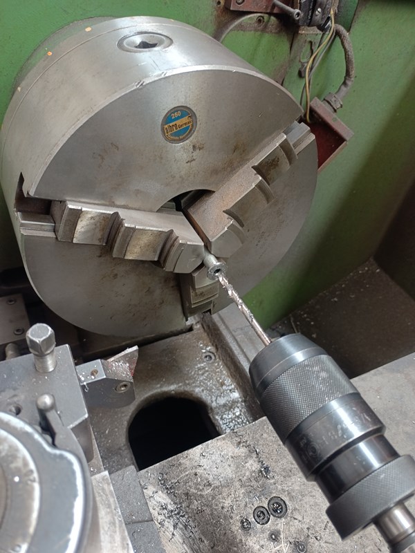 Drill a 5 mm hole through the whole length of the bolt