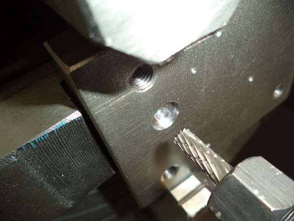 Milling o-ring grooves in a mild steel plate with a cheap router and a tungsten carbide bit