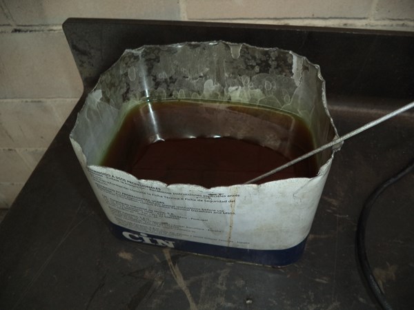 Tin filled with used hydraulic oil