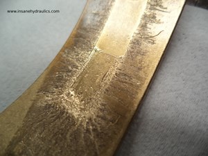 Hard Particle Damage to Cradle Bearing Surface