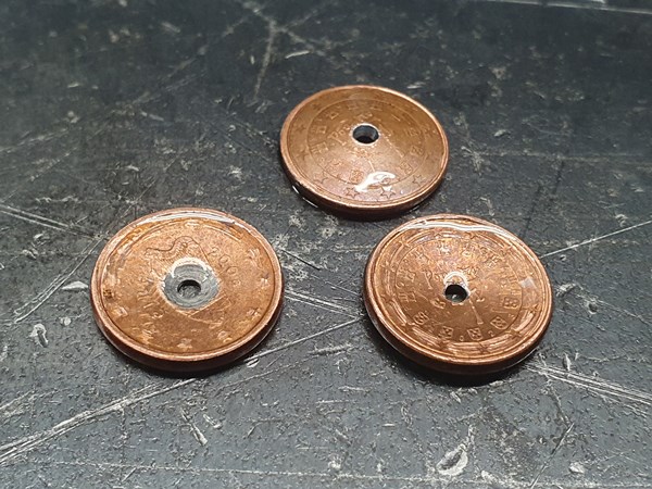 The coins got deformed by the pressure differential