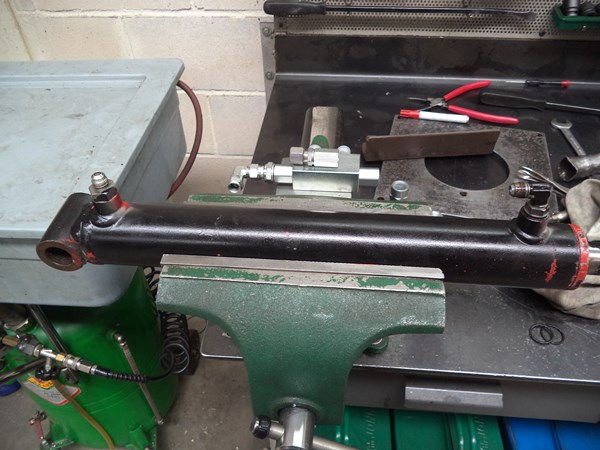 This looks like a cylinder with normal hydraulic fittings, but one of them is special