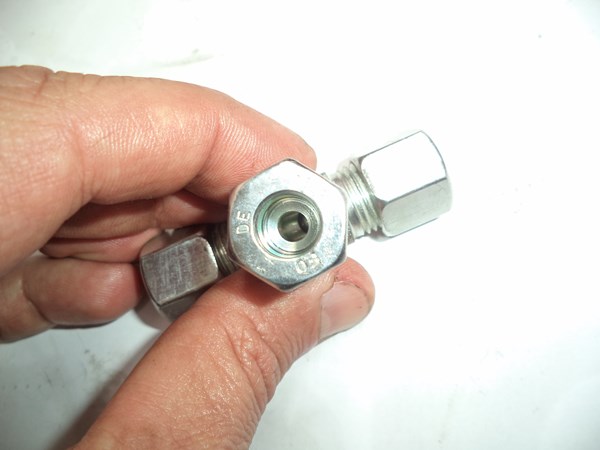 Steel ball visible inside the shuttle valve